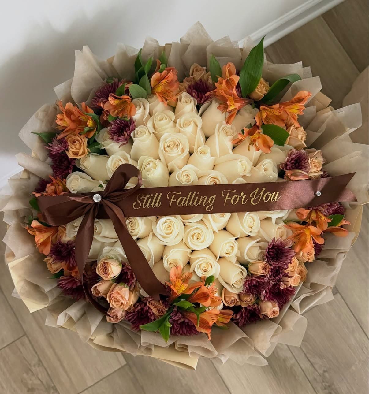 Still Falling For You fall bouquet β cream roses with orange and burgundy blooms
