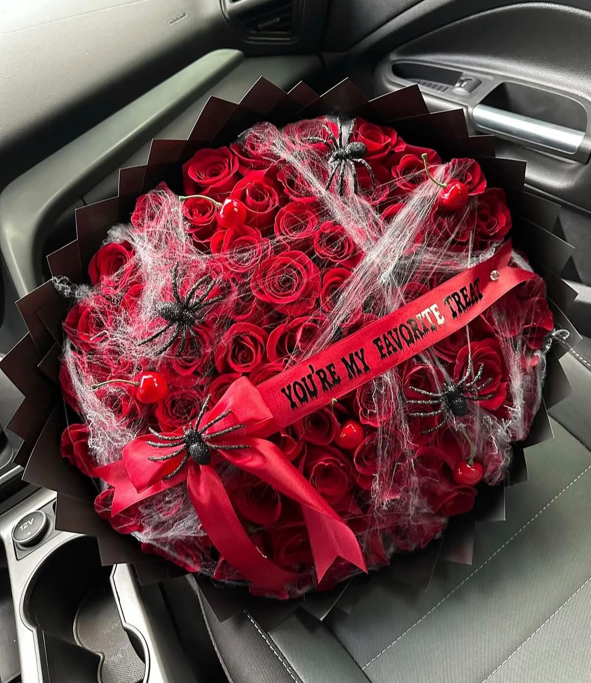 Halloween bouquet of red roses with spiderwebs and a Youβre My Favorite Treat ribbon